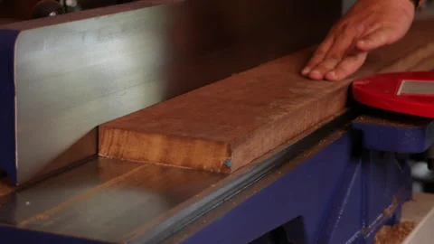 Man sawing wood on a jointer in a home workshop 動画素材 281165143