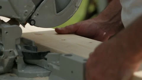 Man sawing wood using electric saw outside in the garden, closeup Stock Footage 135526329