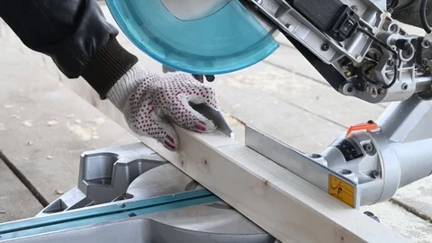 Man sawing wood using a miter saw Stock Footage 119370062