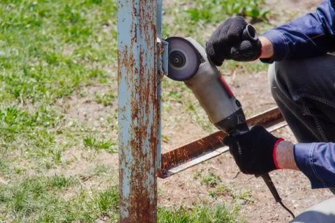 The Man Saws Angular Grinding Machine Iron Details of the fence. Stock Photos