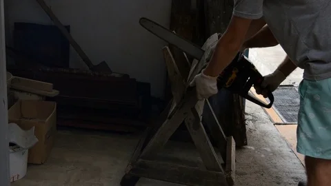 Man saws a board with a chainsaw Stock-Footage 80176992