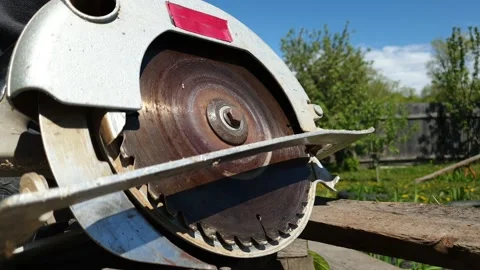 A man saws a Board with an electric circular saw, close-up Stock Footage 130812623