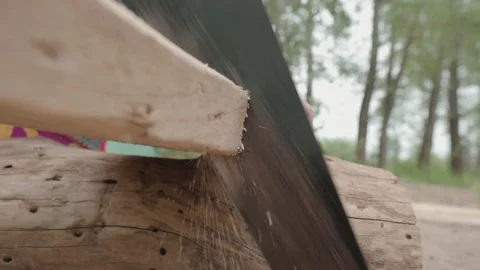 A man saws a board with a hand saw. Stock Footage 142187656