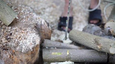 A man saws a log with an chain saw. Process of sawing wood with an chain saw Stock Footage 163138586