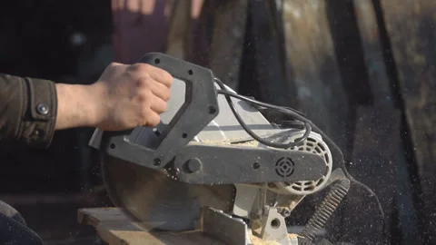 Man saws the materials from the tree with a saw Stock Footage 90552799