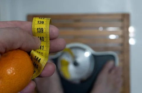 Man on the scale in the bathroom. Fotos de archivo