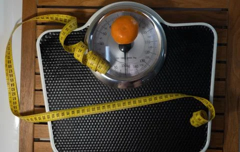 Man on the scale in the bathroom. Stock Photos