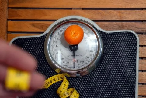 Man on the scale in the bathroom. Stock Photos