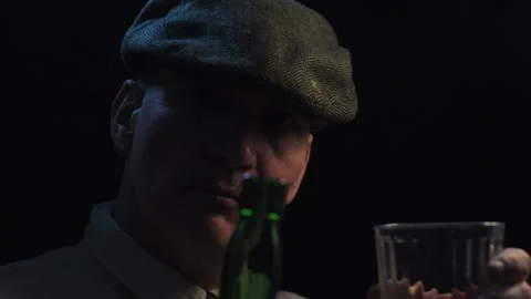 Man in Scally Cap Pouring and Drinking Whiskey Video stock 233662463