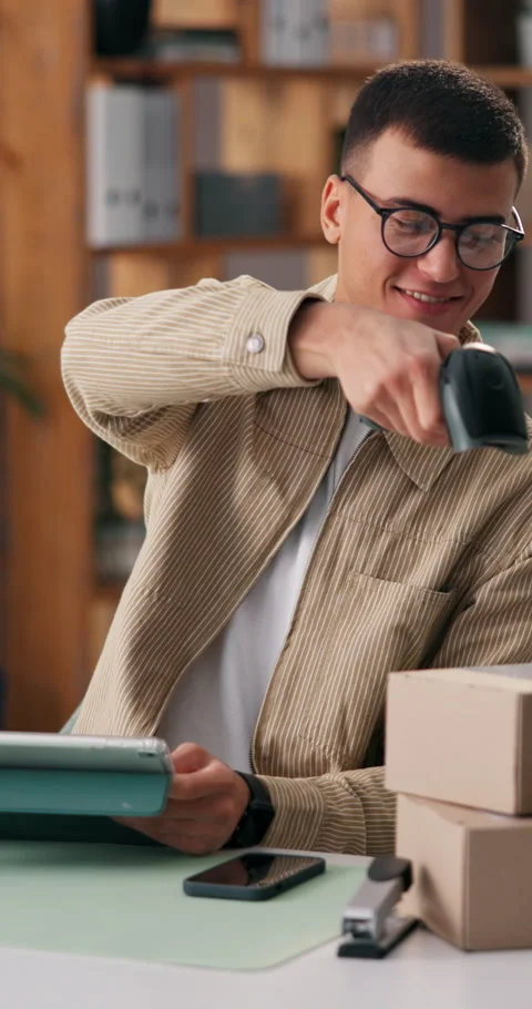 Man, scanner and boxes with tablet in office for logistics, scan barcode and Stock Footage 334315506
