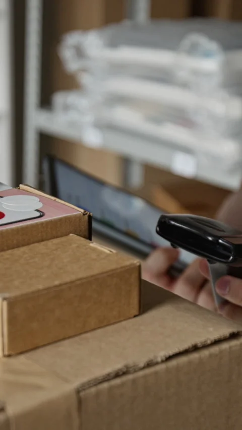 Man Scanning Barcode on Package Using Mobile App in Warehouse Stock Footage 342601857