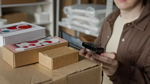 Man Scanning Barcode on Shipping Box Using Tablet in Warehouse Stock Footage 342597438