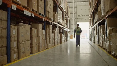 Man scanning barcodes through barcode reader at warehouse. Stock Footage 119360505