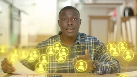 Man scanning papers then addressing camera while explaining tech network overlay Stock Footage 333925415