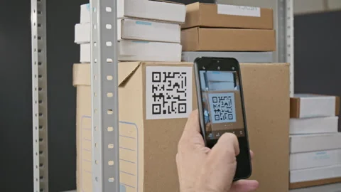 Man Scanning Qr Code on Box with Smartphone in Warehouse Stock Footage 346054300