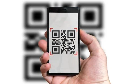 Man is scanning QR code with camera in mobile phone. Stock Photos