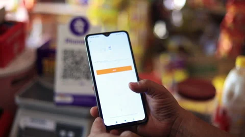 A man scanning a QR code for making a payment Video stock 274464339