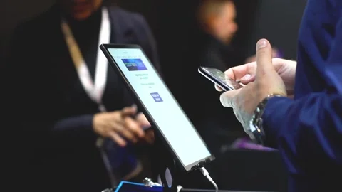 A man scanning QR code via smartphone at an exhibition Stock Footage 248691755