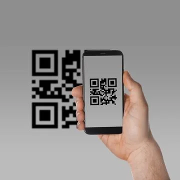 Man scanning QR code with smartphone on light grey background, closeup Stock Photos