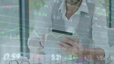 Man scanning tablet after market update, comparing charts with papers while Stock Footage 335762080