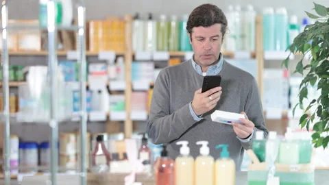 Man scans code on package of ointment to check the expiration date Stock Footage 309526170