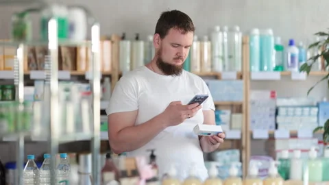 Man scans code on package of ointment to check the expiration date Stock Footage 318434290