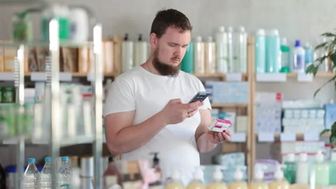 Man scans code on package of paracetamol pills to check the expiration date Stock Footage 318946610