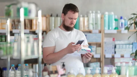 Man scans code on package of pills to check the expiration date Stock Footage 312229076