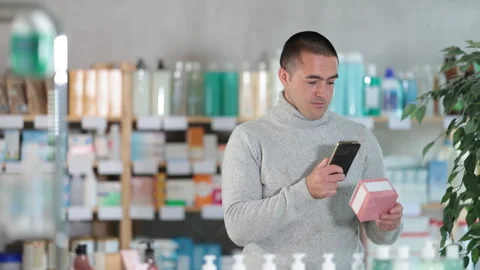 Man scans code on package of pills to check the expiration date Stock-Footage 346648759