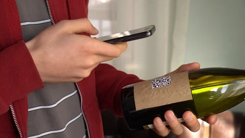 A man scans the QR code and are taken to a Nutrition Facts label online Stock Footage 129660009