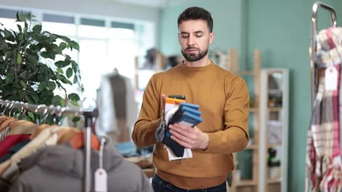 Man scans QR code and label of socks Stock Footage 331302994