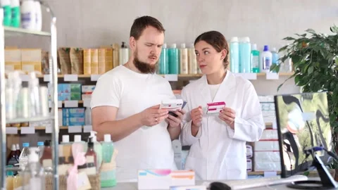 Man scans QR code on box paracetamol pills label. Female pharmacist offers to Video stock 318942053