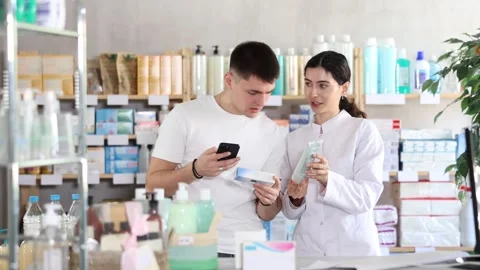 Man scans QR code on box medicated ointment or gel label. Female pharmacist Stock Footage 327132274