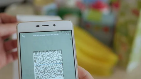 A man scans the QR code on a check from a supermarket. 스톡 동영상 88578608