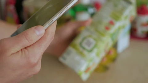 A man scans the QR code on a check on a juice box from a supermarket. 스톡 동영상 88578710