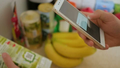 A man scans the QR code on a check on a juice box from a supermarket. 스톡 동영상 88578766