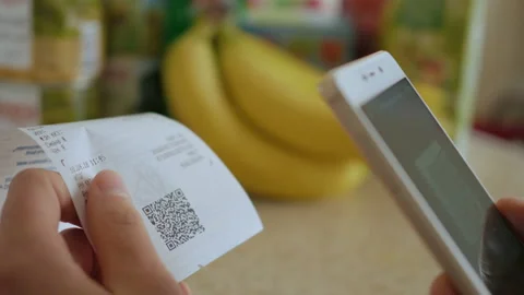 A man scans the QR code on a check from a supermarket. Stock Footage 88588452