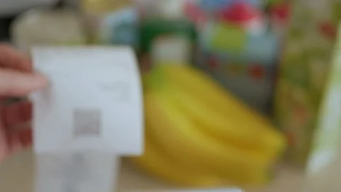 A man scans the QR code on a check from a supermarket. 스톡 동영상 100724893