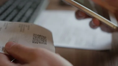 A man scans the QR code on a check from a supermarket. 스톡 동영상 100724928