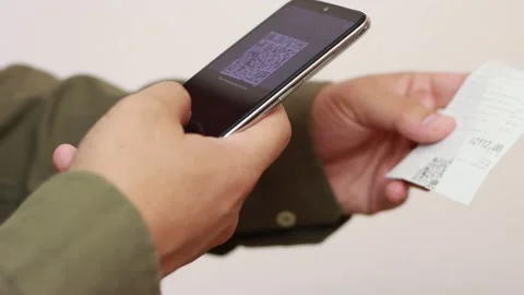 Man scans the QR code on a check Stock Footage 161084949