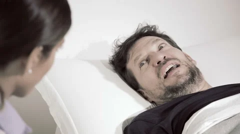 Man scared about getting operation talking to doctor in hospital closeup desa Stock Footage 62892396