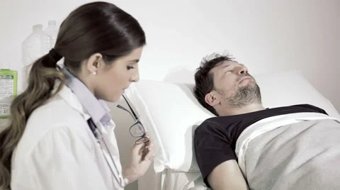 Man scared about getting operation talking to doctor in hospital medium shot Stock Footage 62893385