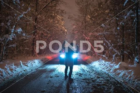 The man scared the car on the snowy road. evening night time Stock Photos