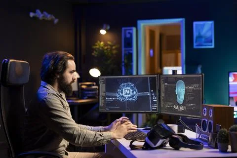 Man scared while programming after AI becomes sentient Stock Photos