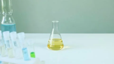 Man scientist is analyzing with a pipette a liquid golden yellow Stock-Footage 140515225