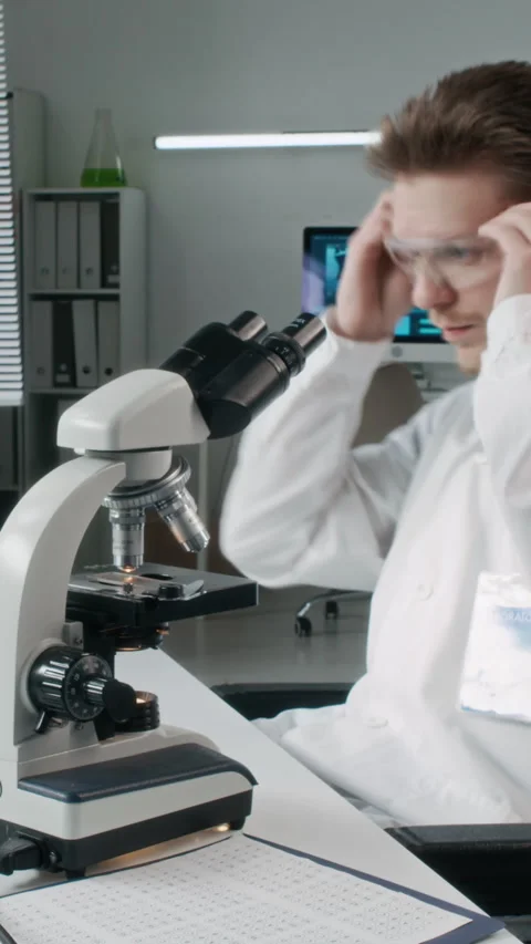 Man Scientist Analyzing Samples at Desk in Laboratory Time Lapse Vertical Stock Footage 330677339