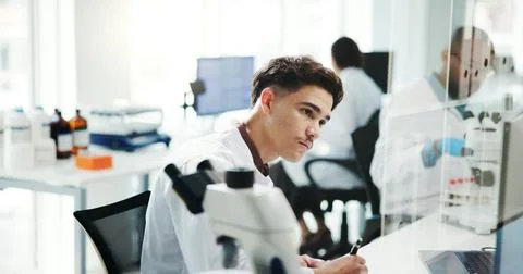 Man, scientist and notes with computer in lab of medical research, experiment or Foto stock