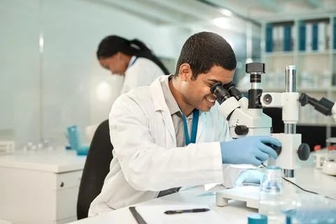 Man, scientist and smile with microscope in lab for research, studying samp.. Stock Photos