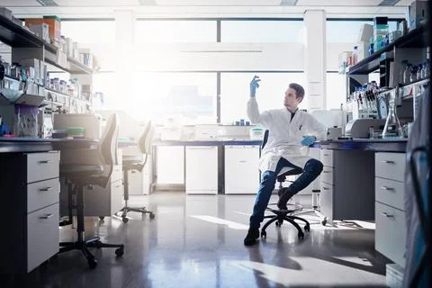 Man, scientist and study in lab with container, research and testing sample.. Stock Photos