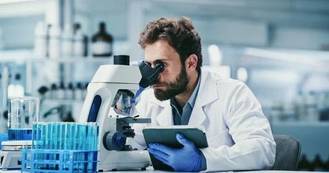 Man, scientist or tablet with microscope in laboratory for medical research.. Stock Photos